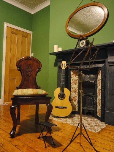The Horsforth teaching room, with a classical guitar and music stand